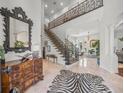 Grand foyer featuring a staircase with ornate wrought iron railings and light-filled space at 124 Estado Ne Way, St Petersburg, FL 33704