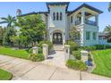 Stately home featuring an ornate front door, stone walkway, manicured landscaping, and classic architecture at 124 Estado Ne Way, St Petersburg, FL 33704