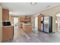 Lovely kitchen featuring a central island, stainless steel appliances and new laminate flooring at 12502 Tocci Ln, Riverview, FL 33579