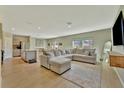 Spacious living room featuring modern furnishings, an open layout, and natural light at 12950 Pasture Woods Pl, Lithia, FL 33547