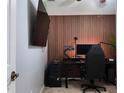 Cozy bedroom with custom wood paneling, perfect for a home office setup at 13653 Artesa Bell Dr, Riverview, FL 33579