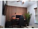 Cozy bedroom with custom wood paneling, perfect for a home office setup at 13653 Artesa Bell Dr, Riverview, FL 33579