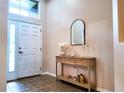 Bright foyer featuring a stylish console table and decorative mirror at 13653 Artesa Bell Dr, Riverview, FL 33579