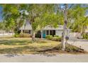 Charming single-story home featuring lush landscaping, mature trees, and a well-maintained lawn in a desirable neighborhood at 1501 Wisconsin Ave, Palm Harbor, FL 34683