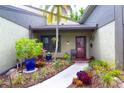 Inviting front entrance with colorful landscaping, featuring a charming doorway and walkway, creating a warm welcome at 2101 Sunset Point Rd # 1806, Clearwater, FL 33765