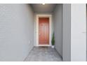 Neutral colored home featuring a solid wood front door and gray brick paver entrance at 2529 Arbor Wind Dr, Lutz, FL 33558