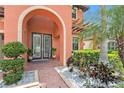 Charming front entrance with double doors, decorative plants, and a 'welcome' sign at 2608 Calvano Dr, Land O Lakes, FL 34639