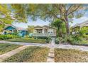 Charming single-story home with green siding, manicured lawn, and a welcoming front porch at 2710 2Nd N Ave, St Petersburg, FL 33713