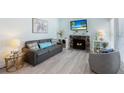 Relaxing living room featuring a cozy fireplace, comfortable seating, and stylish decor at 337 Rex Pl # G, Madeira Beach, FL 33708