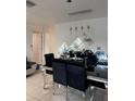Elegant dining room featuring a modern table with black chairs and stylish lighting at 3713 E Clifton St, Tampa, FL 33610