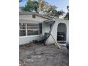 Cozy home exterior with a charming arched entryway and neutral-toned paint at 3713 E Clifton St, Tampa, FL 33610