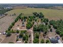Expansive property showcasing a home nestled among mature trees and neighboring farm fields at 38824 Raiser Rd, Dade City, FL 33525