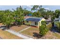 Aerial shot of a charming yellow house with solar panels and a lovely screened porch at 4517 2Nd S Ave, St Petersburg, FL 33711