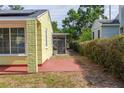 Side view showcasing the backyard, including a screened-in porch and brick facade at 4517 2Nd S Ave, St Petersburg, FL 33711