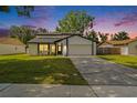 Inviting two-story home featuring a well-manicured lawn and an attached two-car garage at 4914 Country Hills Dr, Tampa, FL 33624