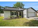Charming home featuring a well-manicured lawn, tidy landscaping, and a two-car garage at 4914 Country Hills Dr, Tampa, FL 33624