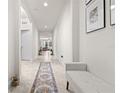 Bright hallway with tile flooring, neutral paint, recessed lighting, and arched doorways at 5048 Inshore Landing Dr, Apollo Beach, FL 33572