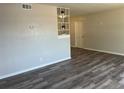 Spacious living room featuring modern gray wood floors and neutral wall colors at 5660 86Th Ave, Pinellas Park, FL 33782