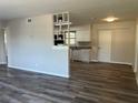 Open floor plan showcasing the living room and kitchen area, with new flooring at 5660 86Th Ave, Pinellas Park, FL 33782