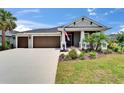 Inviting single-story home with a manicured lawn and a spacious three-car garage, perfect for a growing Gathering at 5828 Clairwood Ct, Palmetto, FL 34221