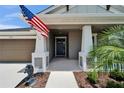 Welcoming front entrance showcasing elegant columns, lush landscaping, and a charming dolphin statue at 5828 Clairwood Ct, Palmetto, FL 34221