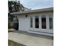 Backyard features a covered patio with access to the home through french doors at 627 E Davis Blvd, Tampa, FL 33606
