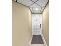 Neutral-toned entryway featuring a door with unit number and tiled floors for a clean and welcoming entrance at 6295 Bahia Del Mar Cir # 406, St Petersburg, FL 33715