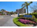 Exterior view of building entrance with manicured landscaping, signage, and convenient ramp access at 6295 Bahia Del Mar Cir # 406, St Petersburg, FL 33715