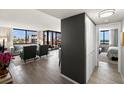 Open-concept living room with wood floors, stylish furnishings, and expansive windows offering scenic views at 6295 Bahia Del Mar Cir # 406, St Petersburg, FL 33715