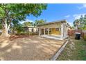 Charming single-story home with a carport, gravel parking, and mature trees in the front yard at 6415 13Th N Ave, St Petersburg, FL 33710