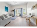 Cozy living room with neutral tones, a balcony with natural light, and minimalist décor at 736 Coral Reef Dr, Tampa, FL 33602