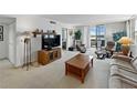 Spacious living room with a relaxing seating area and scenic water view from the balcony at 7665 Sun Island S Dr # 307, South Pasadena, FL 33707