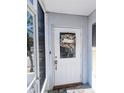 Close-up of the front door adorned with a decorative wreath and welcome mat at 810 Bluewater Dr, Sun City Center, FL 33573