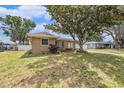 Charming single-story home with mature landscaping and an expansive front yard at 109 S Nimbus Ave, Clearwater, FL 33765