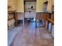 Tiled kitchen area ready for renovation, featuring upper cabinets and exposed plumbing at 1234 11Th Se Cir, Largo, FL 33771