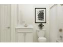Well-lit bathroom with a vanity, toilet, shower, and contemporary decor at 12694 Lily Quartz Loop, Parrish, FL 34219