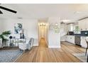 Bright, open-concept living area featuring modern finishes, wood floors, and a view of the kitchen at 1607 34Th E Ave, Bradenton, FL 34208