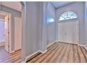 Bright foyer with high ceilings, wood floors, and a large arched window above the front door at 1639 Wakefield Dr, Brandon, FL 33511
