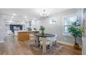 Contemporary dining room with sleek furnishings, modern lighting, and an open layout to the kitchen at 1715 N Alexander Rd, Tampa, FL 33603