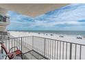 Balcony view of the beach with white railings and a blue sky at 18650 Gulf Blvd # 203, Indian Shores, FL 33785