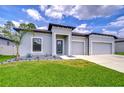 Charming single-story home with well-manicured lawn and a modern design at 18657 Obregan Dr, Spring Hill, FL 34610