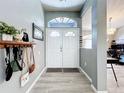 Welcoming foyer features stylish decor, modern lighting, and a view into the spacious living area at 21626 Rosewood Ct, Lutz, FL 33549