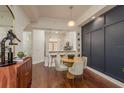 Dining area with wood floors, accent wall, open concept to kitchen area at 2221 Soho Bay Ct, Tampa, FL 33606
