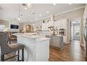 Bright kitchen with white cabinets, granite countertops, stainless steel appliances and breakfast bar at 26701 Winged Elm Dr, Wesley Chapel, FL 33544