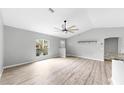 Bright living room with stylish floors, large windows, and modern ceiling fan at 2675 Cherokee St, North Port, FL 34286