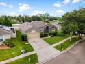Beautiful home featuring a large driveway, verdant lawn, and mature trees in a desirable neighborhood setting at 2808 Abbey Grove Dr, Valrico, FL 33594