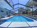 Beautiful in-ground pool with a screened-in enclosure, offering a private oasis for relaxation at 30456 Willow Bank Ave, Brooksville, FL 34602