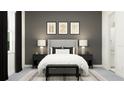 Sophisticated bedroom with a gray upholstered headboard, patterned pillows, stylish bedside lamps, and elegant black curtains at 31597 Cardinal Yard Dr, San Antonio, FL 33576