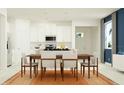 Modern dining area with sleek table and chairs next to the bright open kitchen space at 31718 Griffin Sands Ln, San Antonio, FL 33576