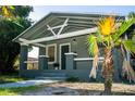 Cozy home featuring a covered porch and decorative palm tree in the front yard at 3515 E 8Th Ave, Tampa, FL 33605